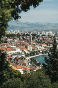 Split old town, bell tower and Riva seen through Marjan pines in high summer