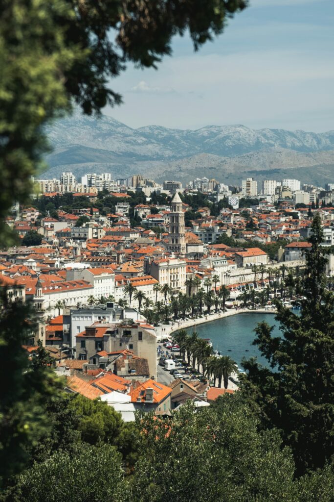 Split old town, bell tower and Riva seen through Marjan pines in high summer