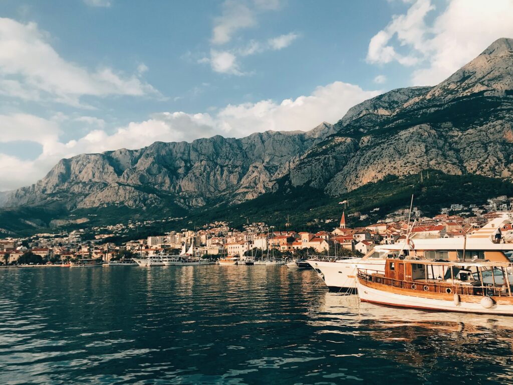 Makarska harbour and old town beneath the Biokovo mountain at golden hour