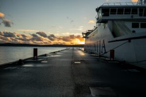 A Jadrolinija ferry moored at the pier at sunset