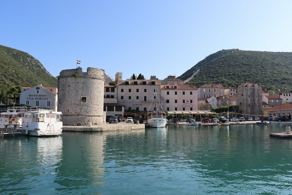 Mali Ston harbour with the round Koruna fortress tower and the Ston walls climbing the hill behind